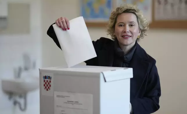 Ivana Kekin, left-green candidate of the (Mozemo) "We Can" party casts her ballot during presidential elections, at a polling station in Zagreb, Croatia, Sunday, Dec. 29, 2024. (AP Photo/Darko Bandic)