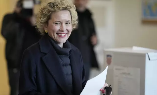 Ivana Kekin, left-green candidate of the (Mozemo) "We Can" arrives at a polling station during presidential elections in Zagreb, Croatia, Sunday, Dec. 29, 2024. (AP Photo/Darko Bandic)