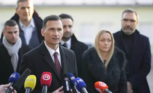 Dragan Primorac, the candidate of the ruling Croatian Democratic Union (HDZ) speaks to the media after casting his ballot during a presidential election at a polling station in Zagreb, Croatia, Sunday, Dec. 29, 2024. (AP Photo/Darko Bandic)