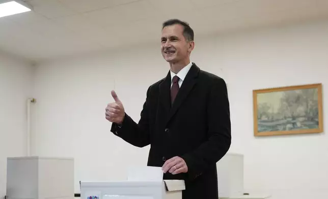 Dragan Primorac, the candidate of the ruling Croatian Democratic Union (HDZ) poses as he casts his ballot during a presidential election at a polling station in Zagreb, Croatia, Sunday, Dec. 29, 2024. (AP Photo/Darko Bandic)