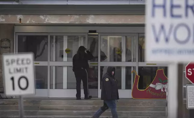 People enter Indiana State Prison where, barring last-minute court action or intervention by Gov. Eric Holcomb, Joseph Corcoran, 49, convicted in the 1997 killings of his brother and three other people, is scheduled to be put to death by lethal injection before sunrise Tuesday, Dec. 17, 2024, in Michigan City, Ind. (AP Photo/Erin Hooley)