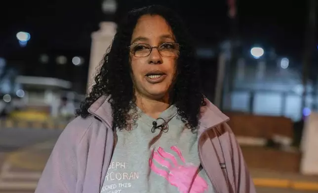 Calling herself his wife, Tahina Corcoran speaks outside of Indiana State Prison where, barring last-minute court action or intervention by Gov. Eric Holcomb, Joseph Corcoran, 49, convicted in the 1997 killings of his brother and three other people, is scheduled to be put to death by lethal injection before sunrise Tuesday, Dec. 17, 2024, in Michigan City, Ind. (AP Photo/Erin Hooley)
