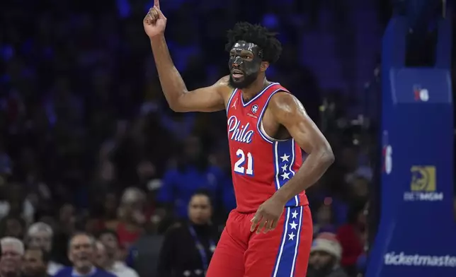 Philadelphia 76ers' Joel Embiid reacts after being fouled during the first half of an NBA basketball game against the Charlotte Hornets, Friday, Dec. 20, 2024, in Philadelphia. (AP Photo/Matt Slocum)