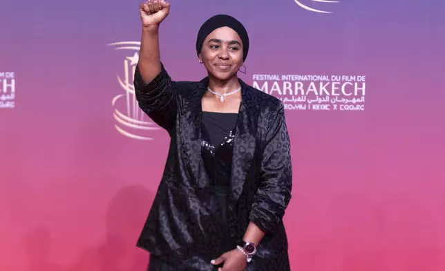 Sudanese actress Shajan Suliman gestures while attending the screening of Sudan Remember Us movie, during the Marrakech International Film Festival, in Morocco, Monday, Dec. 2, 2024. (AP Photo/Mosa'ab Elshamy)