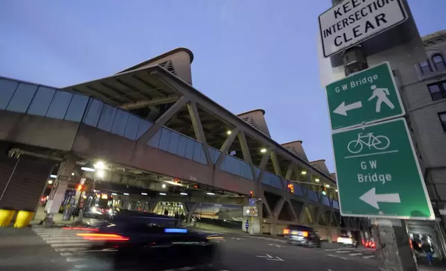 Traffic rolls past the George Washington Bridge Bus Station in New York, Friday, Dec. 6, 2024, where the gunman fleeing Wednesday's shooting of UnitedHealthcare CEO Brian Thompson took a taxi to, according to surveillance video. (AP Photo/Richard Drew)