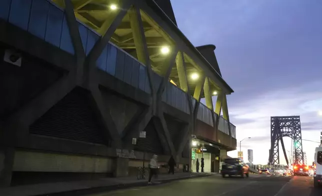 Traffic rolls past the George Washington Bridge Bus Station in New York, Friday, Dec. 6, 2024, near where the gunman fleeing Wednesday's shooting of UnitedHealthcare CEO Brian Thompson took a taxi to, according to surveillance video. (AP Photo/Richard Drew)