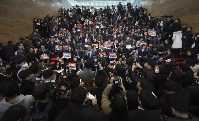 South Korean lawmakers and members of opposition parties gather at the National Assembly in Seoul, South Korea, Friday, Dec. 6, 2024. (AP Photo/Lee Jin-man)
