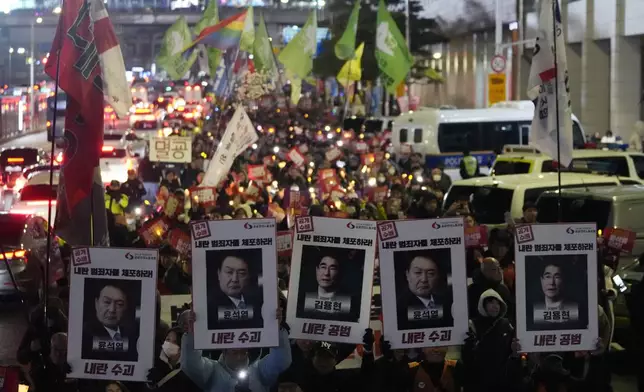 Protesters march to the presidential office after a candlelight vigil against South Korean President Yoon Suk Yeol in Seoul, South Korea, Thursday, Dec. 5, 2024. (AP Photo/Ahn Young-joon)
