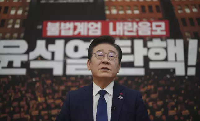 South Korea's main opposition Democratic Party leader Lee Jae-myung speaks during an interview with The Associated Press at the National Assembly in Seoul, South Korea, Friday, Dec. 6, 2024. The part of letters at bottom "Impeachment, Yoon Suk Yeol." (AP Photo/Lee Jin-man)