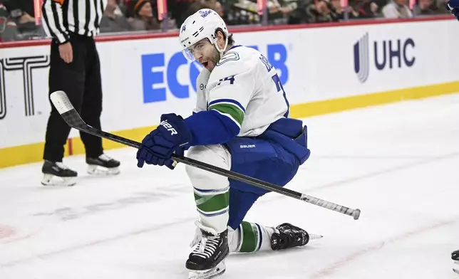 Vancouver Canucks left wing Jake DeBrusk celebrates after scoring a goal against the Minnesota Wild during the second period of an NHL hockey game Tuesday, Dec. 3, 2024, in St. Paul, Minn. (AP Photo/Craig Lassig)