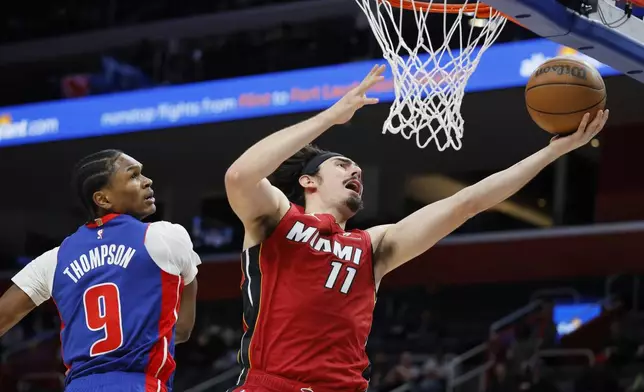 Miami Heat guard Jaime Jaquez Jr. (11) goes to the basket past Detroit Pistons forward Ausar Thompson (9) during the first half of an NBA basketball game Monday, Dec. 16, 2024, in Detroit. (AP Photo/Duane Burleson)