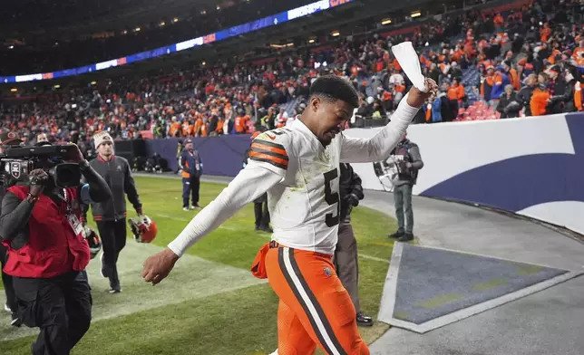 Cleveland Browns quarterback Jameis Winston pulls off his headband while heading into the locker room after an NFL football game against the Denver Broncos Monday, Dec. 2, 2024, in Denver. (AP Photo/David Zalubowski)