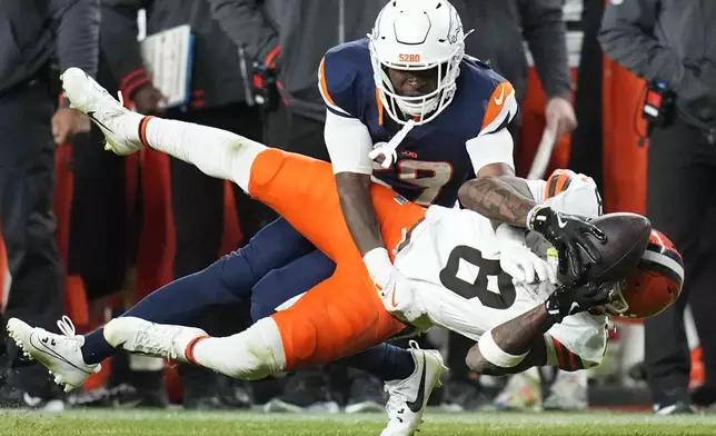 Cleveland Browns wide receiver Elijah Moore (8) is defended by Denver Broncos cornerback Ja'Quan McMillian (29) during the second half of an NFL football game, Monday, Dec. 2, 2024, in Denver. (AP Photo/Jack Dempsey)