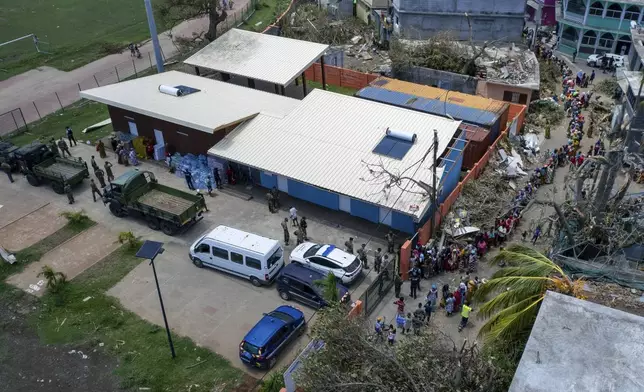 This photo provided by the French Army shows residents queuing outside a military supplies center in the Indian Ocean French territory of Mayotte, Wednesday Dec.18, 2024, as the cyclone on Saturday was the deadliest storm to strike the territory in nearly a century. (D Piatacrrea, Etat Major des Armees/Legion Etrangere via AP)