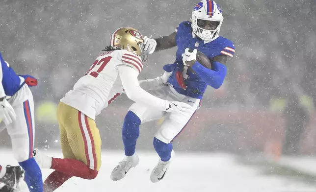 Buffalo Bills wide receiver Curtis Samuel, right, is tackled by San Francisco 49ers safety Ji'Ayir Brown during the second half of an NFL football game in Orchard Park, N.Y., Sunday, Dec. 1, 2024. (AP Photo/Adrian Kraus)