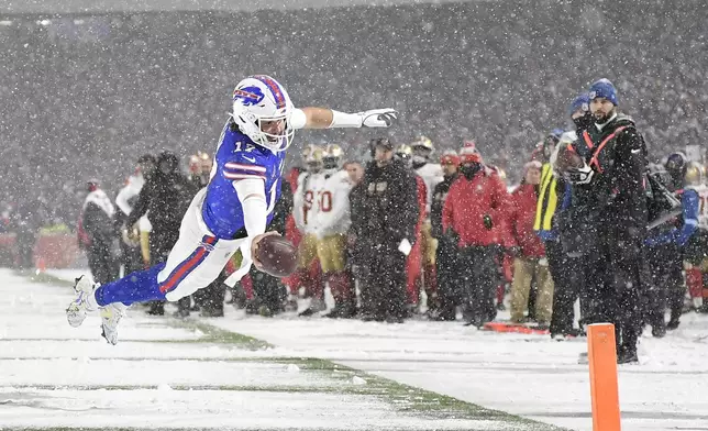 Buffalo Bills quarterback Josh Allen (17) dives for the end zone to score against the San Francisco 49ers during the second half of an NFL football game in Orchard Park, N.Y., Sunday, Dec. 1, 2024. (AP Photo/Adrian Kraus)