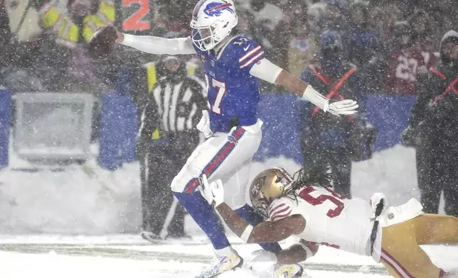 Buffalo Bills quarterback Josh Allen, middle, scores past San Francisco 49ers linebacker Fred Warner during the second half of an NFL football game in Orchard Park, N.Y., Sunday, Dec. 1, 2024. (AP Photo/Gene J. Puskar)