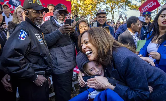 Democratic presidential nominee Vice President Kamala Harris hugs a child after speaking during a campaign event at Washington Crossing Historic Park, in Washington Crossing, Pa., Wednesday, Oct. 16, 2024. (AP Photo/Jacquelyn Martin)