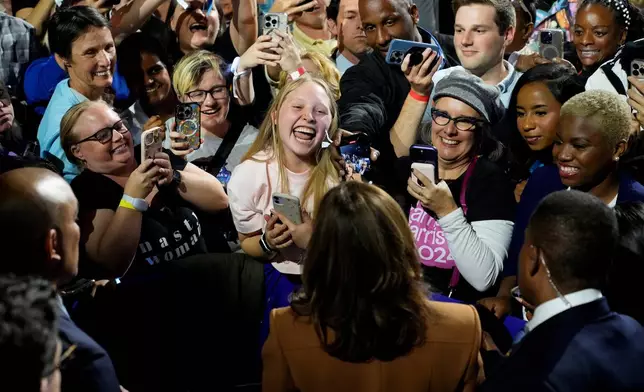 Democratic presidential nominee Vice President Kamala Harris, bottom center, greets supporters after speaking during a campaign rally Saturday, Oct. 26, 2024 at the Wings Event Center in Kalamazoo, Mich. (AP Photo/Jacquelyn Martin)