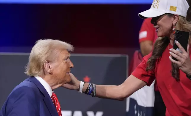 A supporter greets Republican presidential nominee former President Donald Trump after a campaign event at the Cobb Energy Performing Arts Centre, Tuesday, Oct. 15, 2024, in Atlanta. (AP Photo/Alex Brandon)