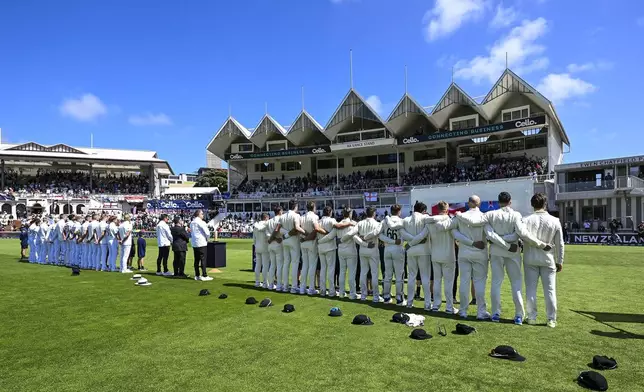 New Zealand, right, and England team's line up ahead of play in the second cricket test between New Zealand and England at the Basin Reserve in Wellington, New Zealand, Friday, Dec.6, 2024. (Andrew Cornaga/Photosport via AP)