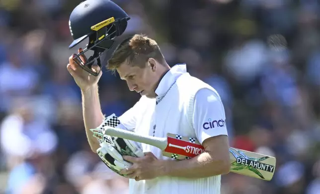 England's Zak Crawley walks from the field after he was out bowled by New Zealand's Matt Henry during play on day one of the second cricket test between New Zealand and England at the Basin Reserve in Wellington, New Zealand, Friday, Dec.6, 2024. (Kerry Marshall/Photosport via AP)