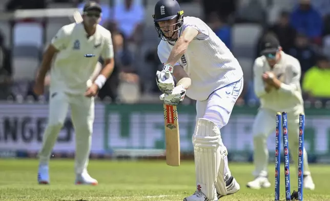 England's Zak Crawley reacts as he is out bowled by New Zealand's Matt Henry during play on day one of the second cricket test between New Zealand and England at the Basin Reserve in Wellington, New Zealand, Friday, Dec.6, 2024. (Andrew Cornaga/Photosport via AP)