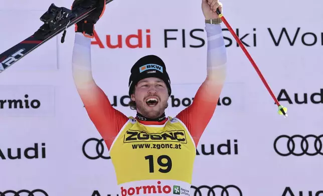 Switzerland's Alexis Monney celebrates after winning an alpine ski, men's World Cup downhill race, in Bormio, Italy, Saturday, Dec. 28, 2024. (AP Photo/Marco Trovati)