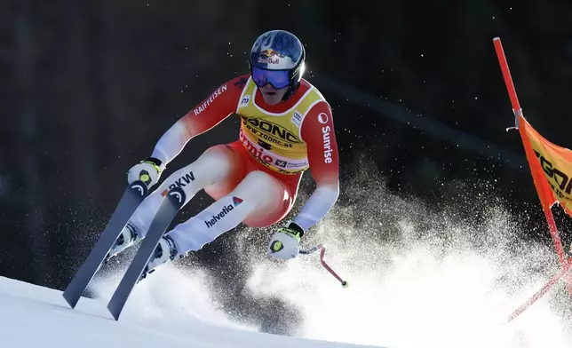 Switzerland's Franjo von Allmen speeds down the course during an alpine ski, men's World Cup downhill race, in Bormio, Italy, Saturday, Dec. 28, 2024. (AP Photo/Gabriele Facciotti)