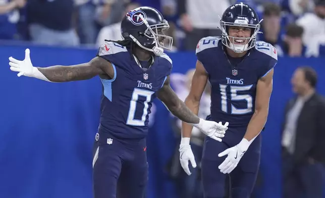 Tennessee Titans wide receiver Calvin Ridley (0) celebrates his touchdown with teammate Nick Westbrook-Ikhine (15) during the first half of an NFL football game against the Indianapolis Colts, Sunday, Dec. 22, 2024, in Indianapolis. (AP Photo/Michael Conroy)