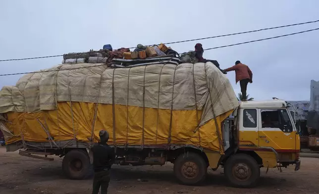 A truck drives through the Epulu village in the Okapi Wildlife Reserve in Congo, Sept. 22, 2024. (AP Photo/Sam Mednick)