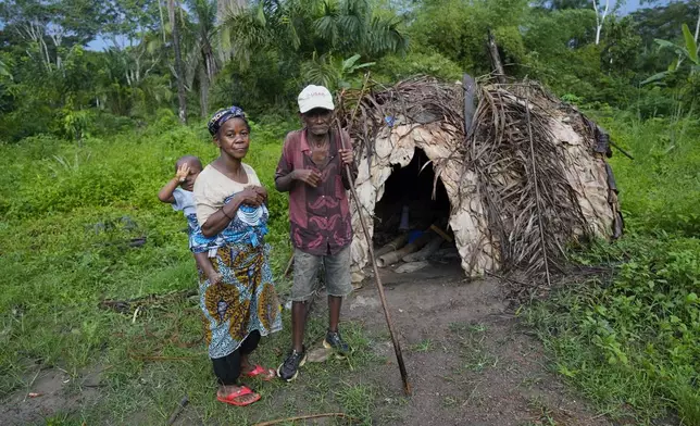 Wendo Olengama, right, a Pygmy chief, stands with his wife Dura Anyainde in their village within the Okapi Wildlife Reserve in Congo, Sept. 22, 2024. (AP Photo/Sam Mednick)