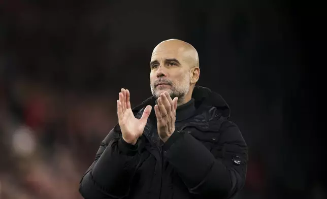 Manchester City's head coach Pep Guardiola applauds the fans at the end of the English Premier League soccer match between Liverpool and Manchester City at Anfield Stadium, Liverpool, England, Sunday Dec. 1, 2024. (AP Photo/Ian Hodgson)