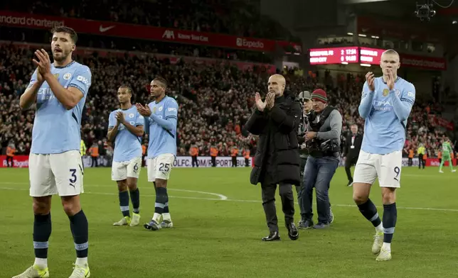 Manchester City's head coach Pep Guardiola, center, and the players applaud the fans at the end of the English Premier League soccer match between Liverpool and Manchester City at Anfield Stadium, Liverpool, England, Sunday Dec. 1, 2024. (AP Photo/Ian Hodgson)