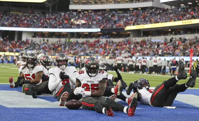 Tampa Bay Buccaneers cornerback Jamel Dean (35) celebrates with teammates after intercepting a pass during the second half of an NFL football game against the Los Angeles Chargers, Sunday, Dec. 15, 2024, in Inglewood, Calif. (AP Photo/Ryan Sun)