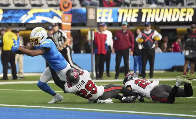 Los Angeles Chargers wide receiver Quentin Johnston (1) scores a touchdown during the first half of an NFL football game against the Tampa Bay Buccaneers, Sunday, Dec. 15, 2024, in Inglewood, Calif. (AP Photo/Eric Thayer)