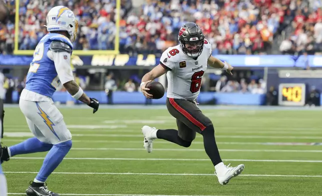 Tampa Bay Buccaneers quarterback Baker Mayfield (6) runs near the end zone during the first half of an NFL football game against the Los Angeles Chargers, Sunday, Dec. 15, 2024, in Inglewood, Calif. (AP Photo/Ryan Sun)