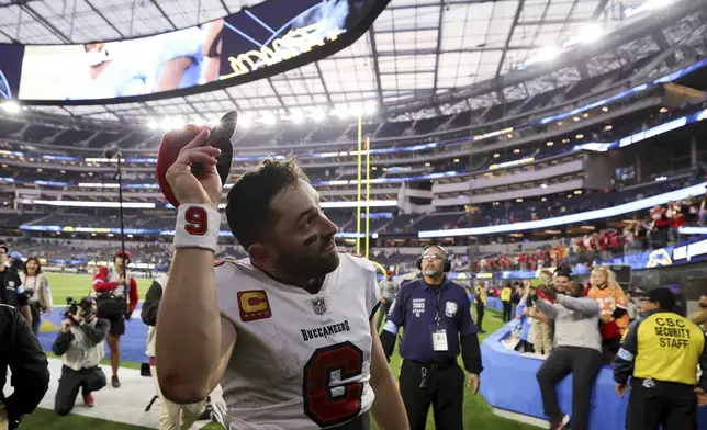 Tampa Bay Buccaneers quarterback Baker Mayfield walks off the field after a win over the Los Angeles Chargers in an NFL football game Sunday, Dec. 15, 2024, in Inglewood, Calif. (AP Photo/Ryan Sun)