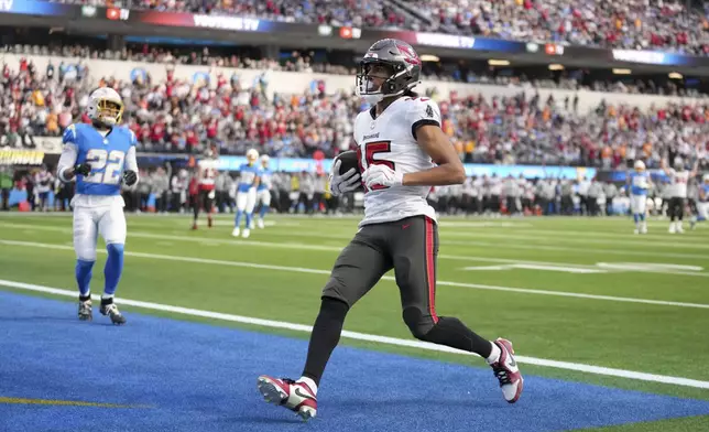 Tampa Bay Buccaneers wide receiver Jalen McMillan (15) scores a touchdown during the first half of an NFL football game against the Los Angeles Chargers, Sunday, Dec. 15, 2024, in Inglewood, Calif. (AP Photo/Eric Thayer)