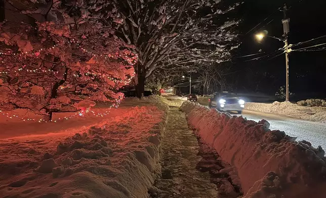 Drivers take advantage of the lull between lake-effect snowfalls in Lowville, N.Y., on Saturday, Nov. 30, 2024. (AP Photo/Cara Anna)