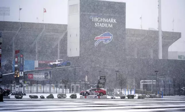 Snow falls on Highmark Stadium and surrounding parking lots in Orchard Park, NY., Saturday, Nov. 30, 2024. The Buffalo Bills play the San Franciso 49ers at Highmark Stadium on Sunday Night Football, Sunday, Dec 1, 2024 at 8:20p. (AP Photo/Gene J. Puskar)