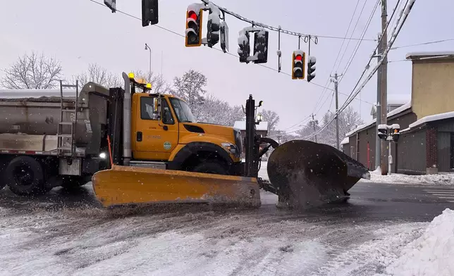 Snow is cleared from the streets in Lowville, N.Y., on Saturday, Nov. 30, 2024. (AP Photo/Cara Anna)