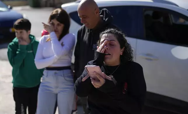 Salma Safadi cries as she speaks with her sister Sawsan Safadi, who lives inside the buffer zone near the so-called Alpha Line that separates the Israeli-controlled Golan Heights from Syria, in the town of Majdal Shams, Tuesday, Dec. 17, 2024. (AP Photo/Matias Delacroix)