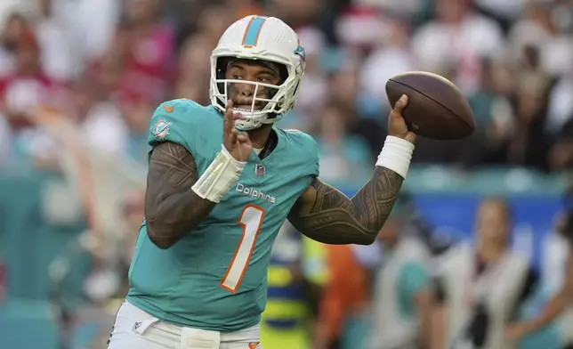 Miami Dolphins quarterback Tua Tagovailoa (1) aims a pass during the first half of an NFL football game against the San Francisco 49ers, Sunday, Dec. 22, 2024, in Miami Gardens, Fla. (AP Photo/Rebecca Blackwell)