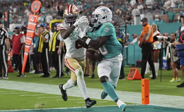 Miami Dolphins wide receiver Tyreek Hill (10) is unable to catch a pass as San Francisco 49ers cornerback Deommodore Lenoir (2) defends during the second half of an NFL football game, Sunday, Dec. 22, 2024, in Miami Gardens, Fla. (AP Photo/Rebecca Blackwell)