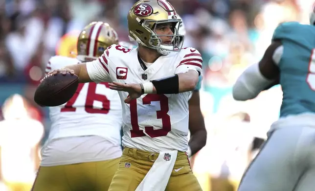 San Francisco 49ers quarterback Brock Purdy (13) aims a pass during the first half of an NFL football game against the Miami Dolphins, Sunday, Dec. 22, 2024, in Miami Gardens, Fla. (AP Photo/Rebecca Blackwell)