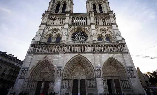 FILE - People stand outside Notre-Dame Cathedral in Paris, on Nov. 29 2024. (Sarah Meyssonnier/Pool Photo via AP, File)