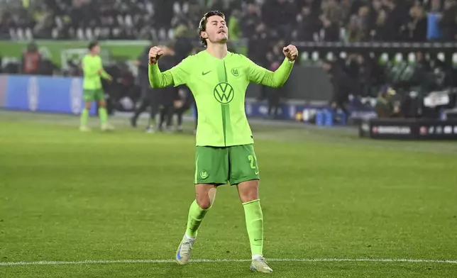 Wolfsburg's Jonas Wind celebrates after scoring during the German Bundesliga soccer match between VfL Wolfsburg and FSV Mainz 05 at the Volkswagen Arena, in Wolfsburg, Germany, Sunday, Dec. 8, 2024. (Swen Pförtner/dpa via AP)