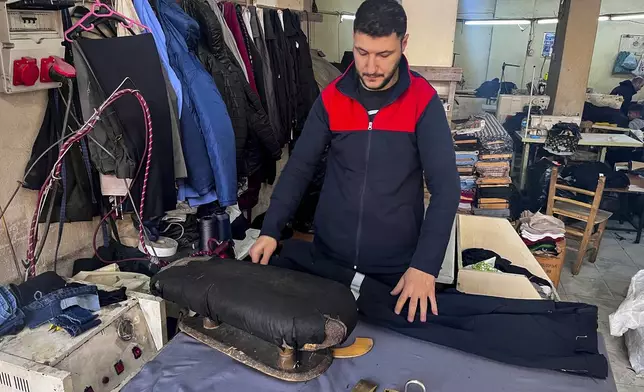 Syrian Mahmut Cabuli works in a textile workshop in Gaziantep, southern Turkey, on Friday, Dec. 13, 2024. (AP Photo/Mehmet Guzel)