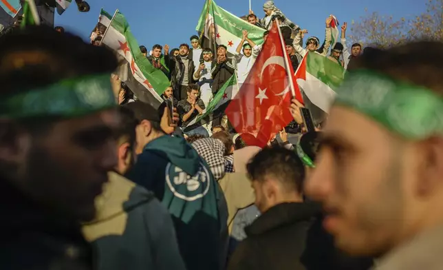 People gather to celebrate the Syrian government's fall in Istanbul, Turkey, on Sunday, Dec. 8, 2024. (AP Photo/Emrah Gurel)